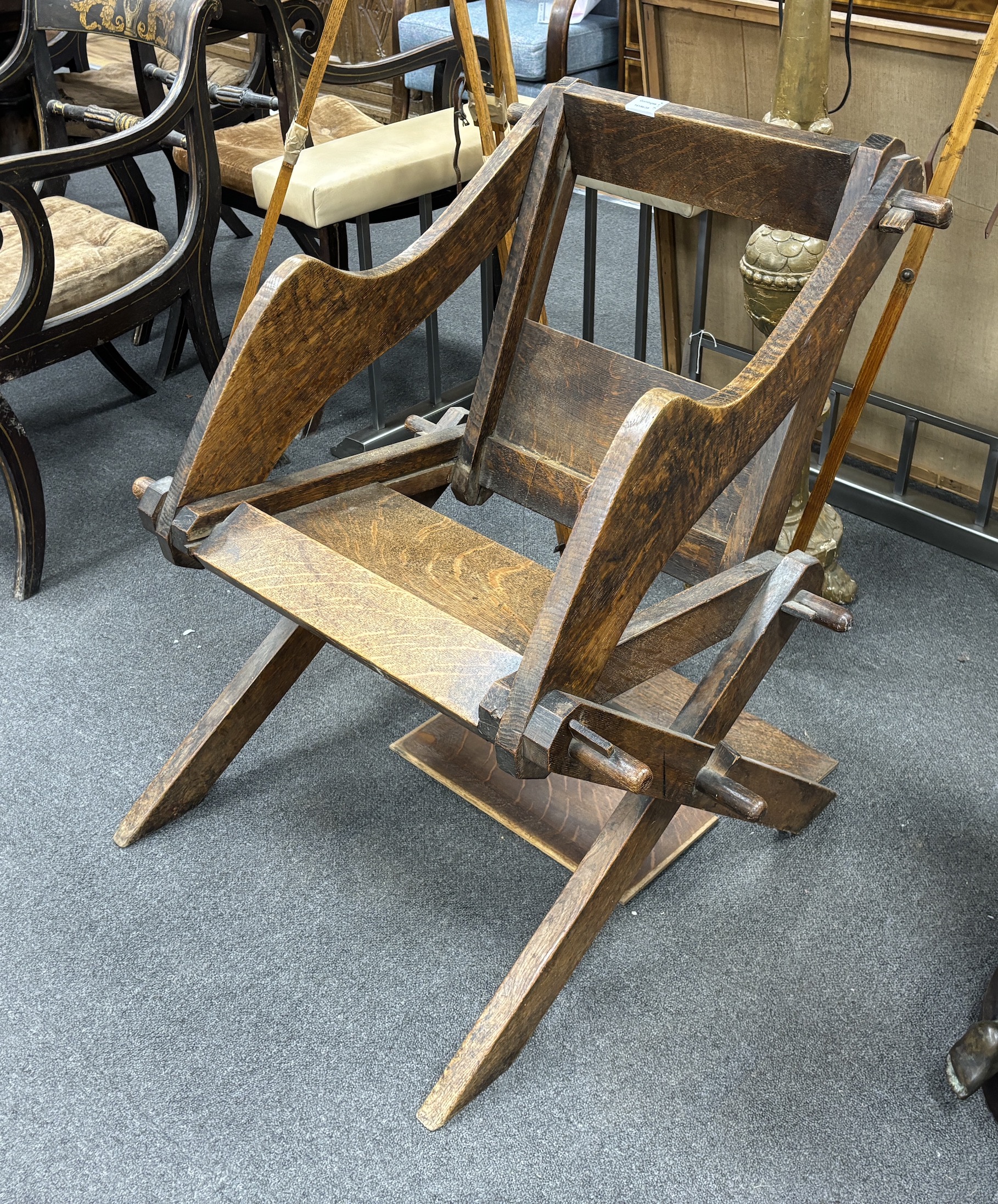 An oak Glastonbury chair, width 74cm, depth 64cm, height 78cm, Provenance- Brede Place, East Sussex, a former residence of the Frewen family from 1712-1936.